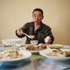Liu Zhaoquan, who works in a fish meal factory in Nouadhibou, Mauritania, eats Chinese dishes from his native Shandong province in the factory canteen. Liu returns home only once every two years. The canteen food is one of the few reminders of home.